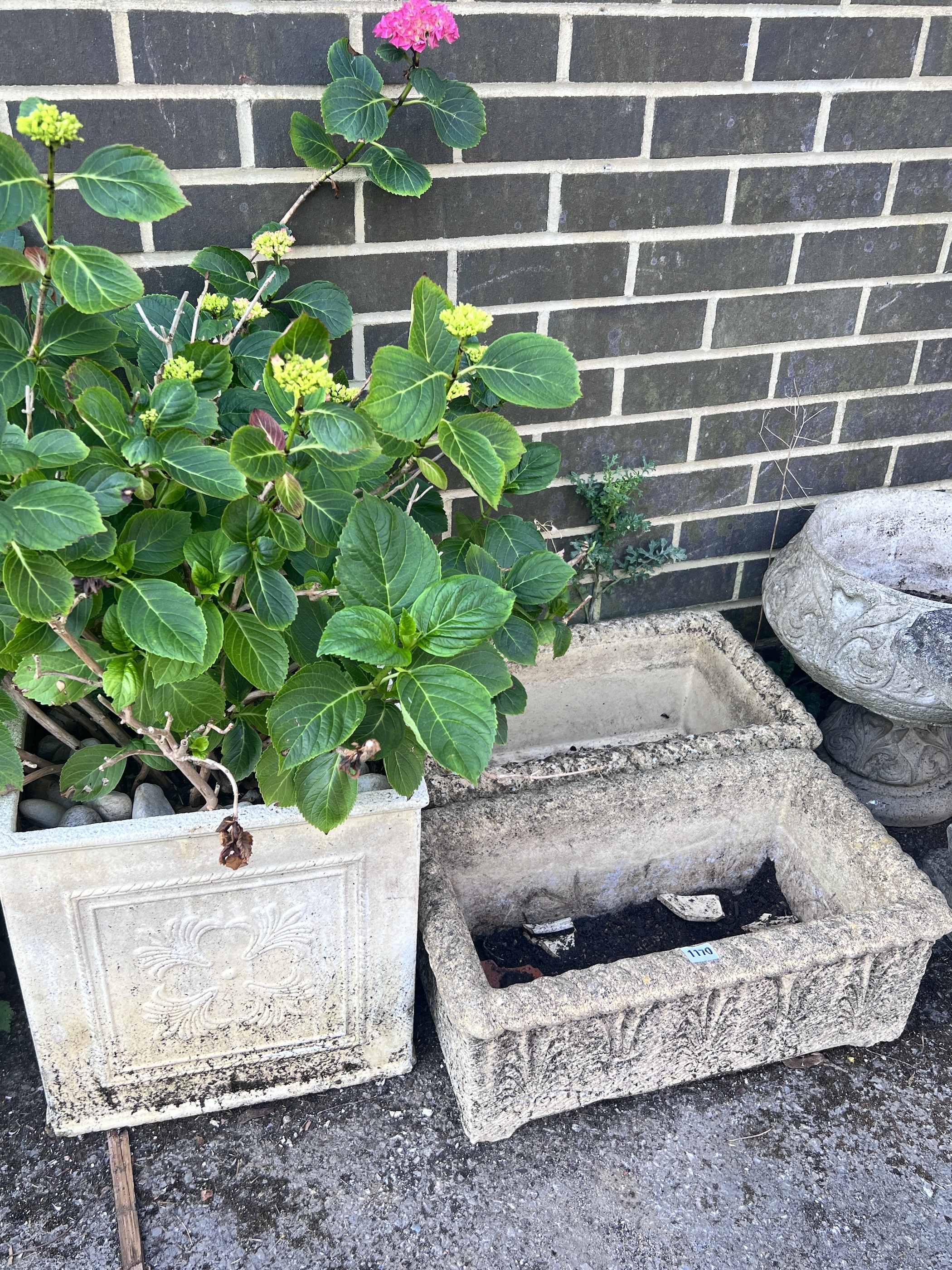 Four reconstituted stone garden planters.